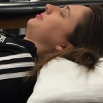 Place curve of your neck over towel roll.